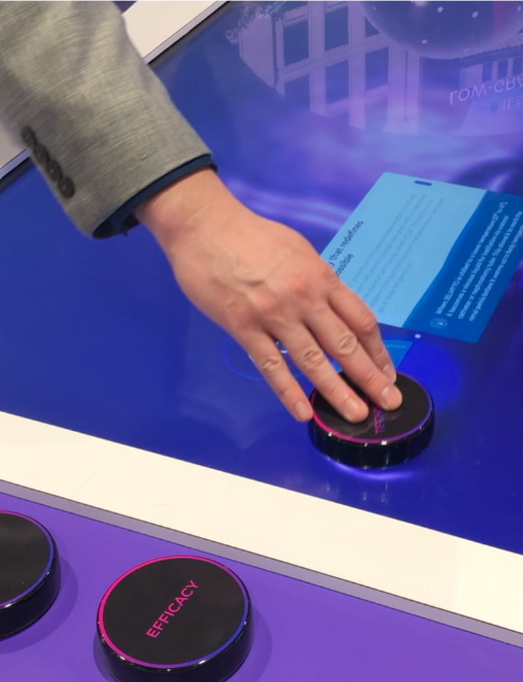 person's hand on a puck, using the gel table